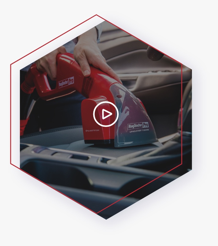 Using the RugDoctor Pro Hand Tool to clean upholstery inside of a car.